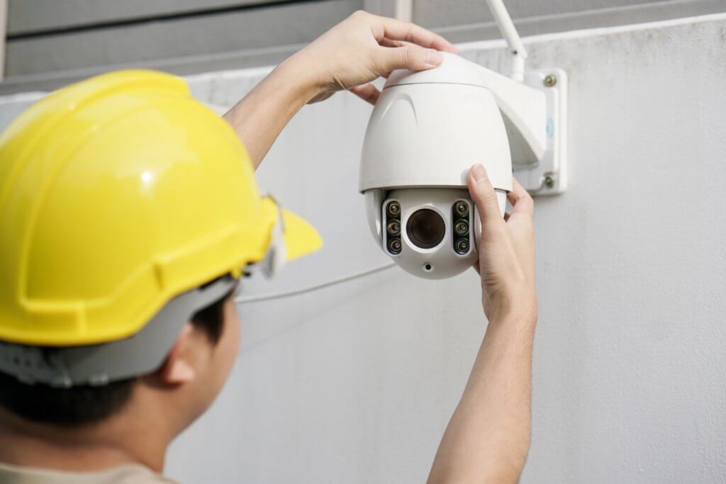 technician installing security camera